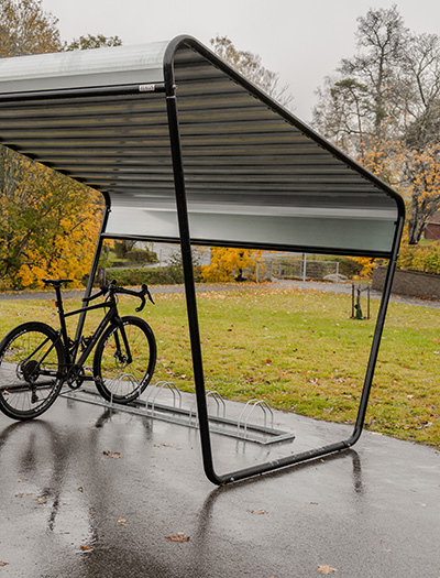 A bicycle shelter by a train station.